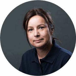 Zahnmedizinische Fachangestellte lächelt in die Kamera.